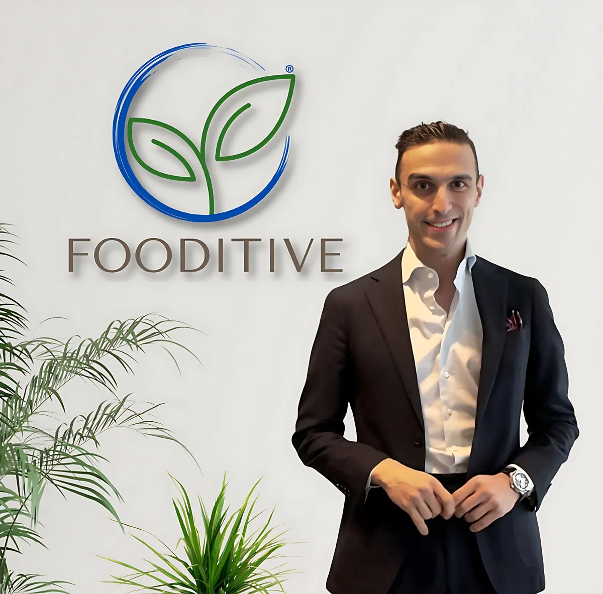 Moayad Abushokhedim, founder and CEO of Fooditive, standing beside the Fooditive logo