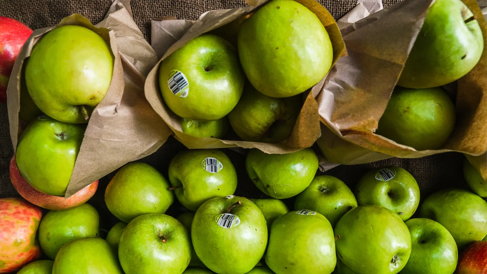 Green apples in brown paper bags