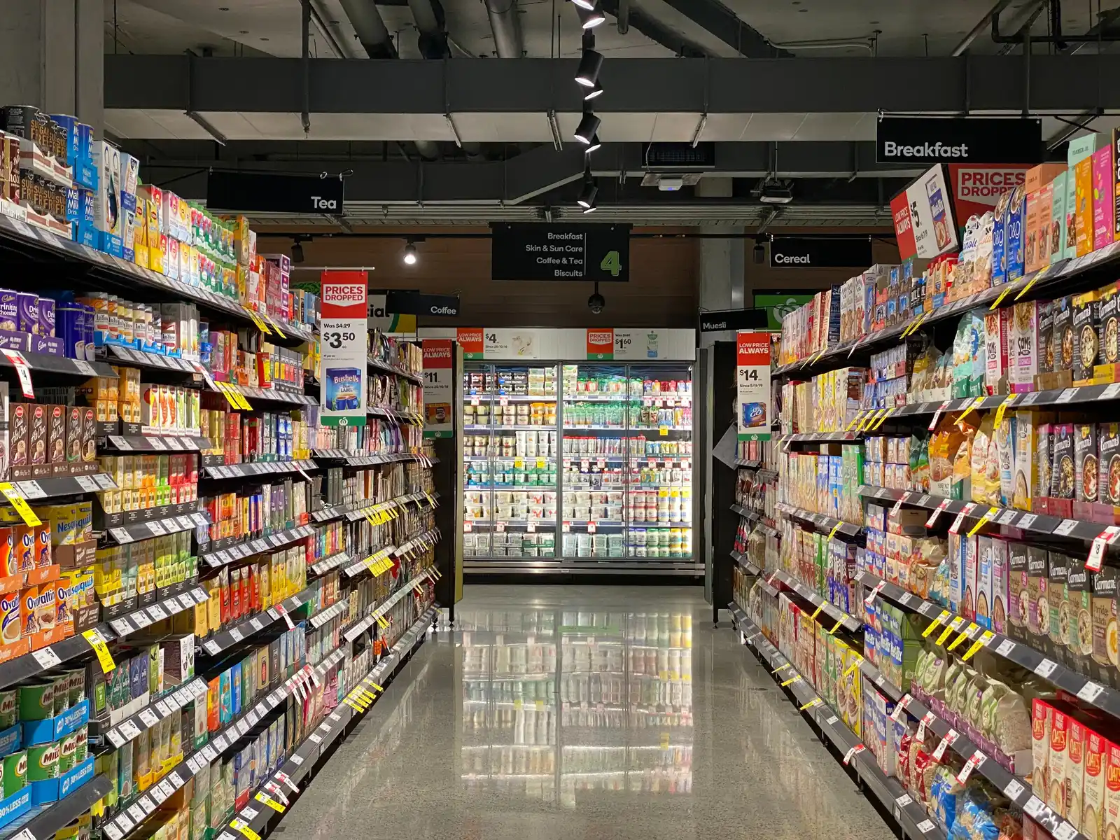 A supermarket aisle with fully stocked shelves of packaged food