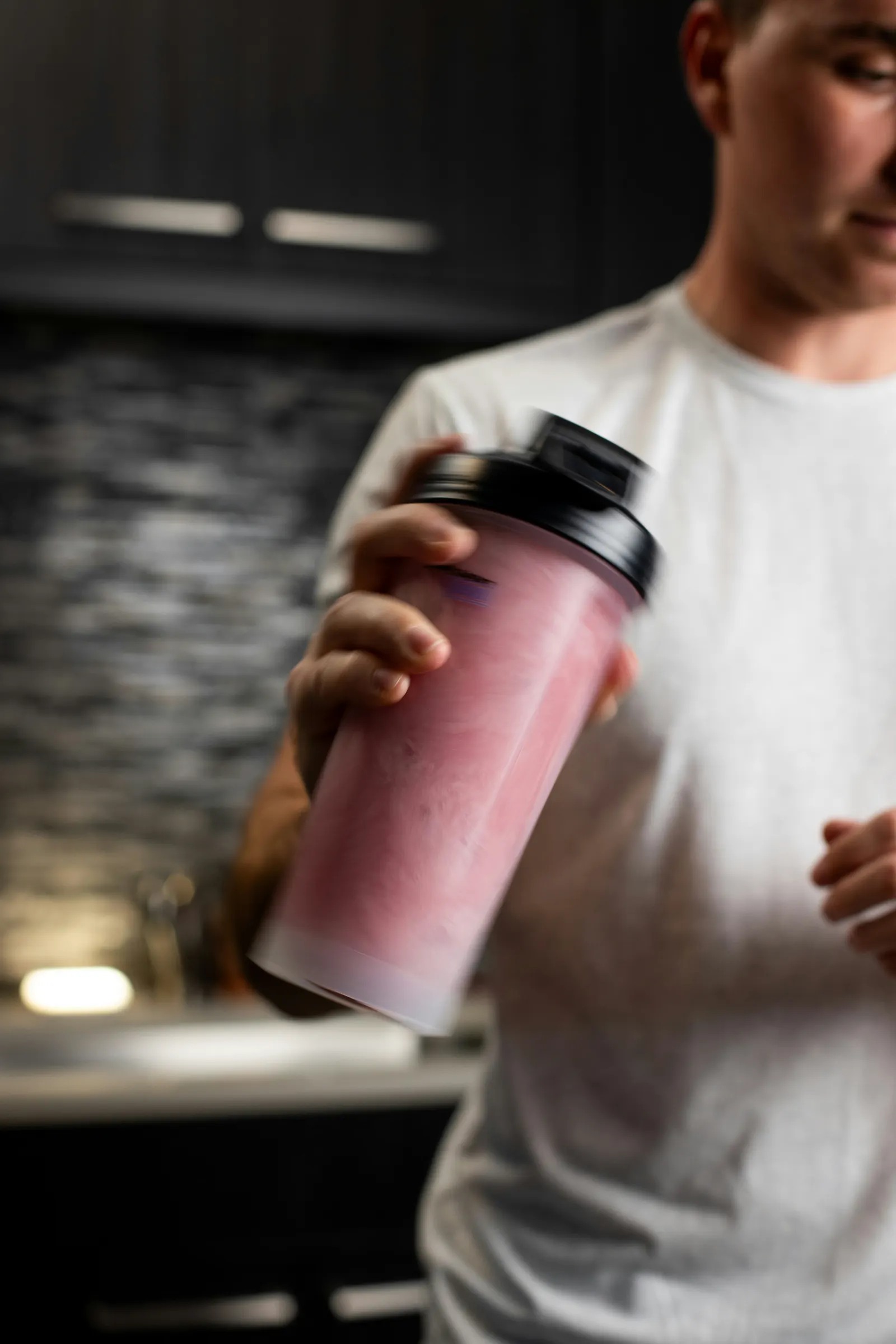 A pink protein shake in a bottle